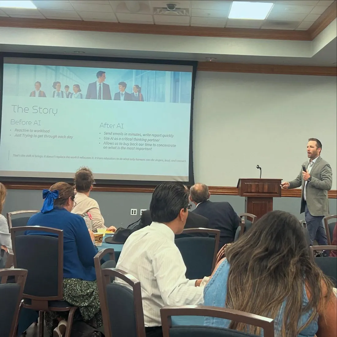 A Freedom Institute speaker delivering a keynote on AI at a conference podium.